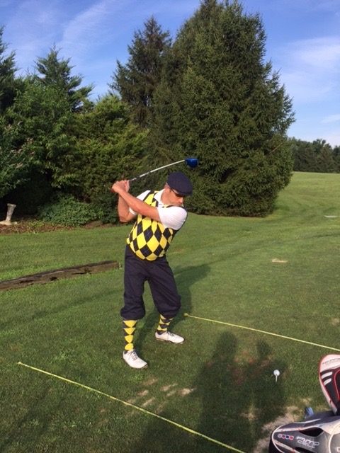 Aaron R. Thomas mid golf swing in argyle